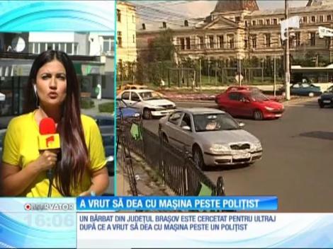 Un bărbat a vrut să dea cu mașina peste un polițist