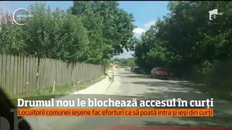 Au șosea nouă, dar îi împiedică să intre în propriile curți. Explicația autoritățile? N-au mai fost bani