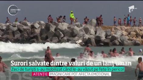 Imagini incredibile surprinse pe plaja din Eforie Nord. Turiştii au făcut lanţ uman ca să salveze din valuri două surori