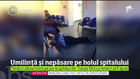 Umilință și nepăsare pe holul Spitalului Judeţean Tulcea. Un tânăr stă întins pe jos fără ca nimeni sș-l ajute!