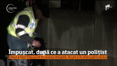 Bărbat împuşcat de un poliţist pe care îl atacase cu toporul