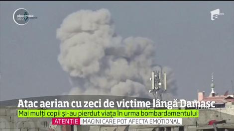 Peste 20 de persoane, inclusiv copii, au fost ucise într-un masiv bombardament aerian la periferia Damascului, într-o zonă controlată de rebelii sirieni