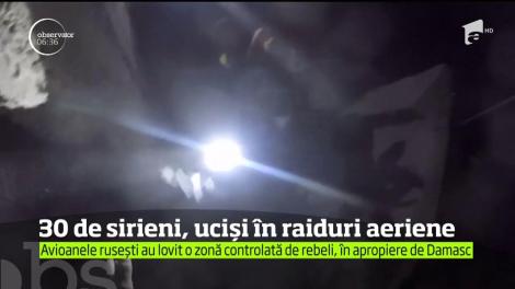 Atenţie, imagini şocante, din iadul sirian! Peste 30 de civili, uciși, în urma unui raid aerian suspect (VIDEO)