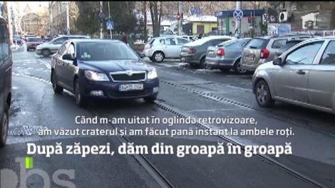 Şoferii sunt nevoiţi să evite adevărate cratere apărute pe carosabil