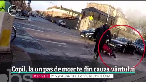 Imagini șocante. Copil, la un pas de a fi călcat de o mașină! Vântul l-a împins în mijlocul șoselei