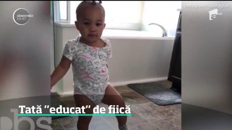 O fetiţă de un an face instrucţie cu tatăl ei, deşi nici măcar nu vorbeşte încă