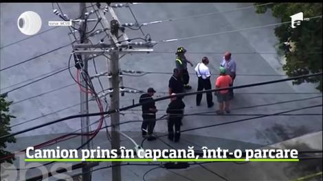 Un camion de mare tonaj a rămas blocat la etajul unei parcări de lângă Boston, după ce planşeul de beton s-a surpat sub greutatea sa