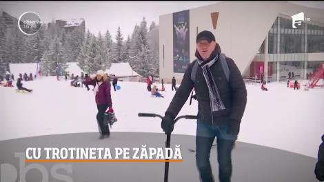 O nouă distracţie a apărut pe pârtiile din Poiana Braşov: trotineta de zăpadă, un fel de placă de snowboard cu mâner, asemănător celui al popularelor vehicule pe două roţi