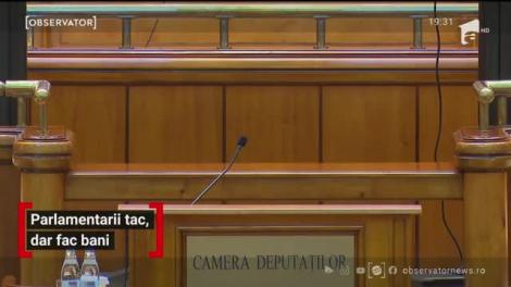 Parlamentarii tac, dar fac bani