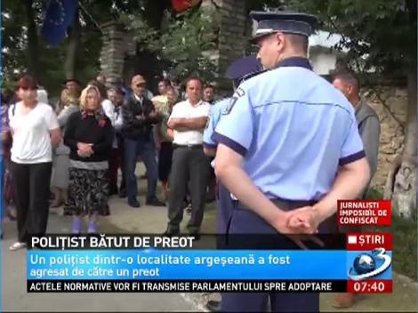 Un poliţist a fost luat la bătaie de un preot