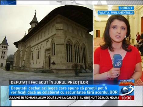 Deputații fac scut în jurul preoților