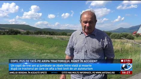 Copil pus de tată pe aripa tractorului, rănit în accident
