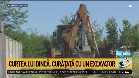 Noi imagini din ancheta de la Caracal. Curtea lui Gheorghe Dincă, curățată cu un excavator