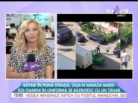 Bătaie în plină stradă! Doi oameni în uniformă se războiesc cu un tânăr