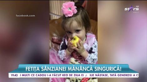 Fetiţa Sânzianei Buruiană mănâncă singurică